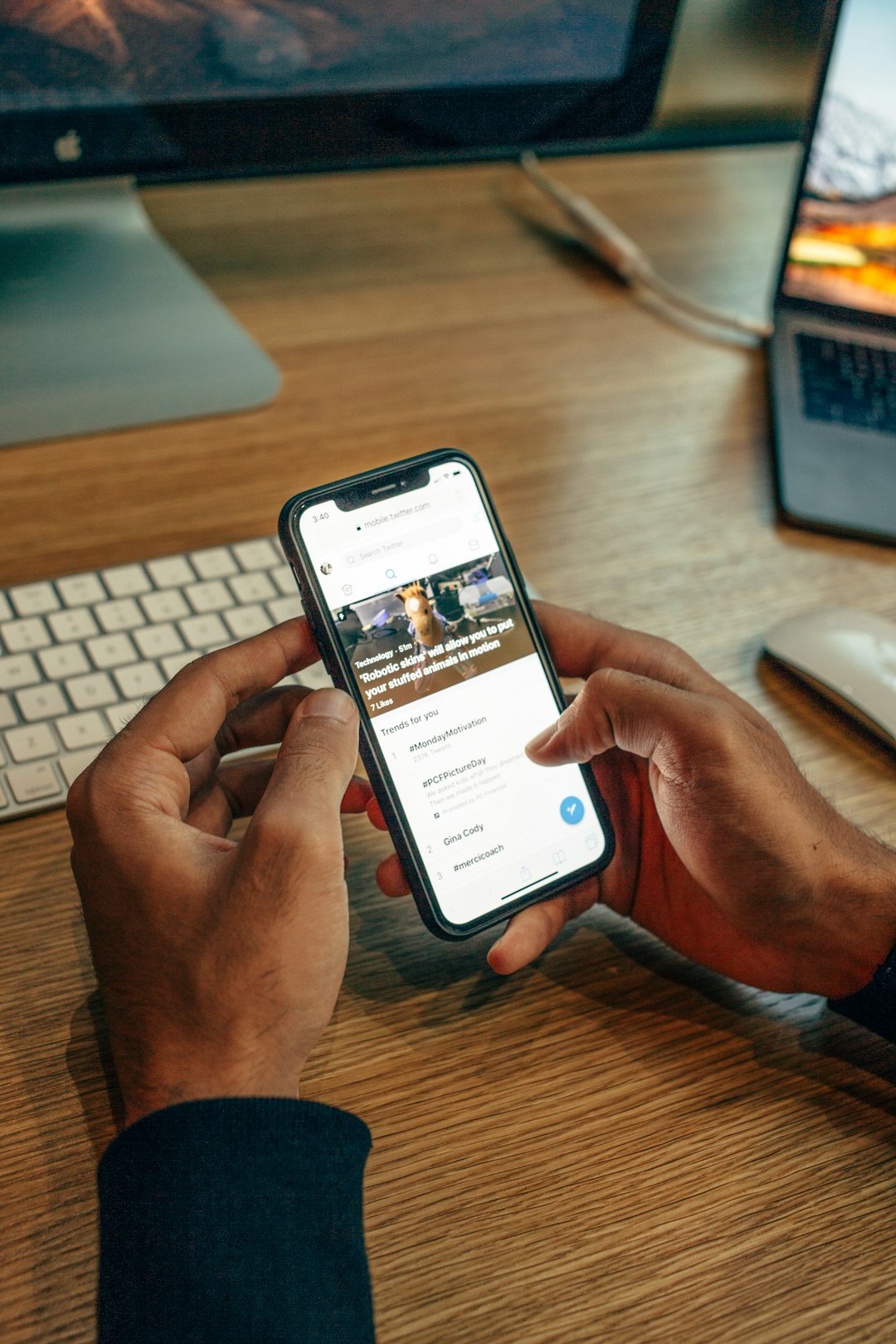 person-holding-iphone-on-table-p0sn8x2htrs